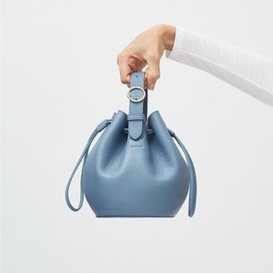 Cuyana bucket bag. Includes cross body strap. New without tags